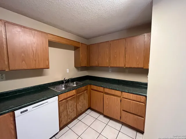 a view of a hallway with wooden shelves