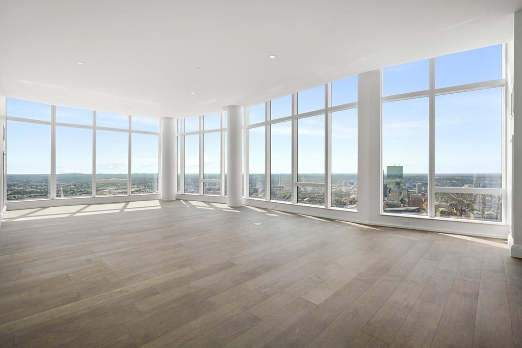 240 Devonshire Street, Unit PH 2C Boston, MA 02110 - Photo 4 of 42 a view of an empty room with wooden floor and windows