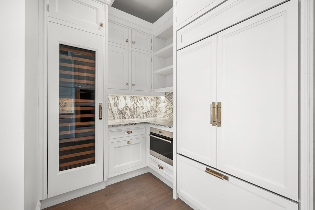 240 Devonshire Street, Unit PH 2C Boston, MA 02110 - Photo 7 of 42 a kitchen with white cabinets and white appliances