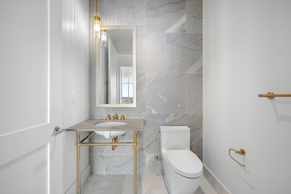 240 Devonshire Street, Unit PH 2C Boston, MA 02110 - Photo 8 of 42 a bathroom with a toilet a sink and mirror