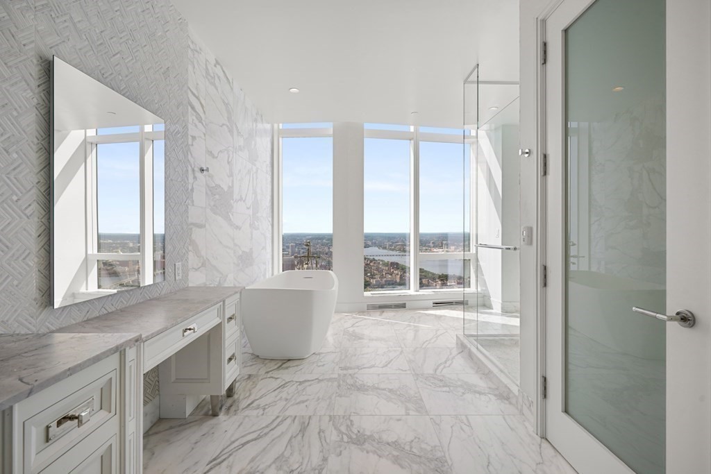240 Devonshire Street, Unit PH 2C Boston, MA 02110 - Photo 10 of 42 a spacious bathroom with a large tub and shower