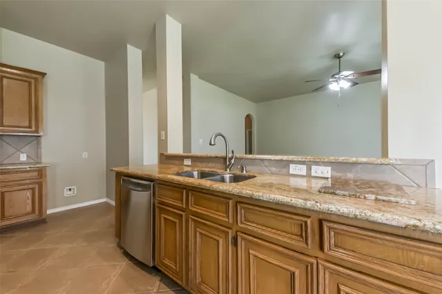 a bathroom with a granite countertop double vanity sink and mirror