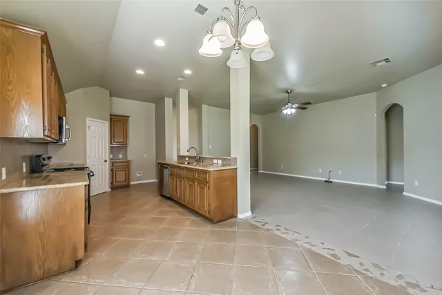 a view of a kitchen with a sink and chandelier
