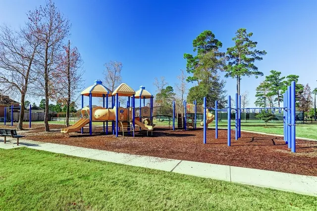 a childrens park with lots of swings and slides