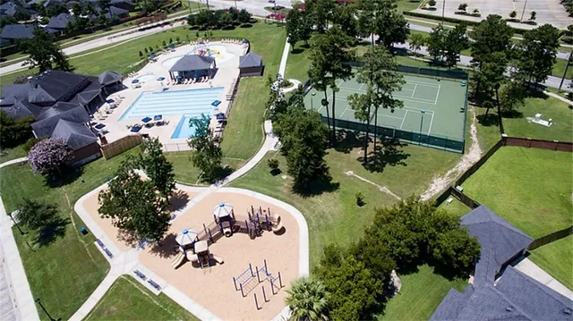 an aerial view of a house with a yard and lake view