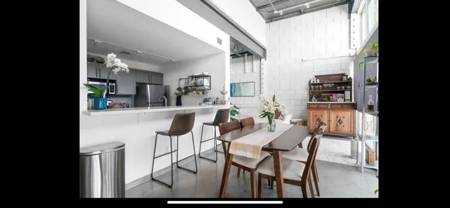 a dining room with furniture and a floor to ceiling window