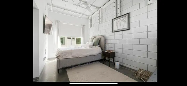 a bed sitting in a bathroom next to a bathroom