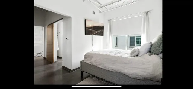 a large white bed in a white room