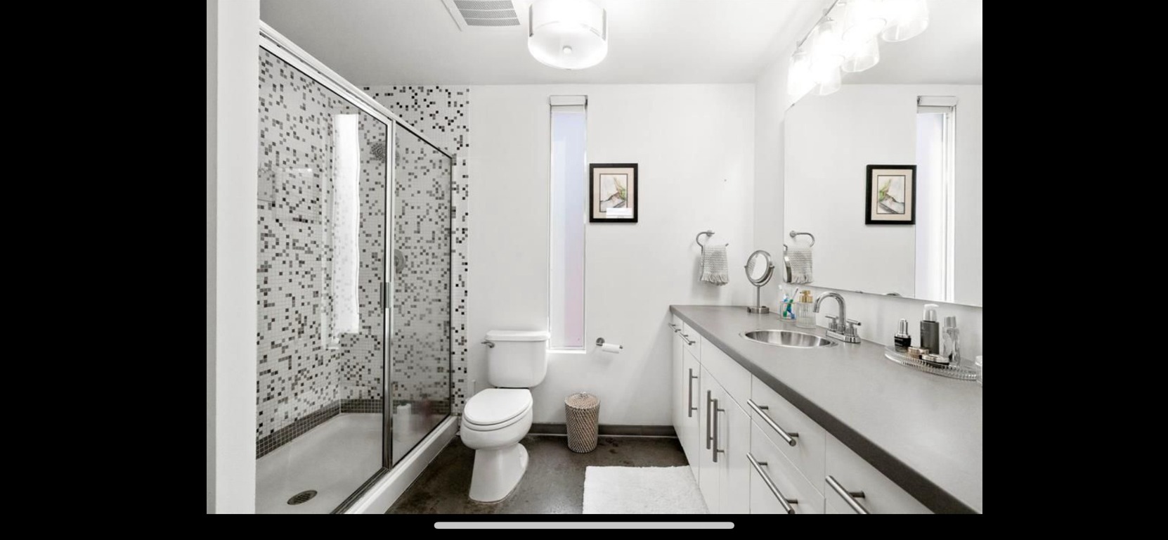 4801 South Congress Avenue, Unit F4 Austin, TX 78745 - Photo 16 of 22 a bathroom with a double vanity sink toilet and shower