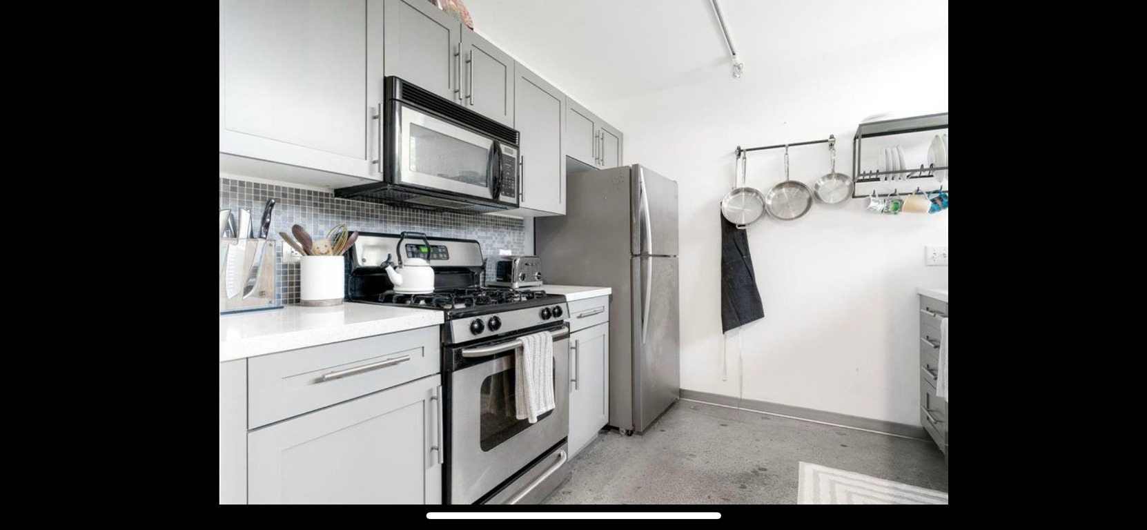 4801 South Congress Avenue, Unit F4 Austin, TX 78745 - Photo 19 of 22 a kitchen with stainless steel appliances granite countertop a stove a refrigerator and a microwave