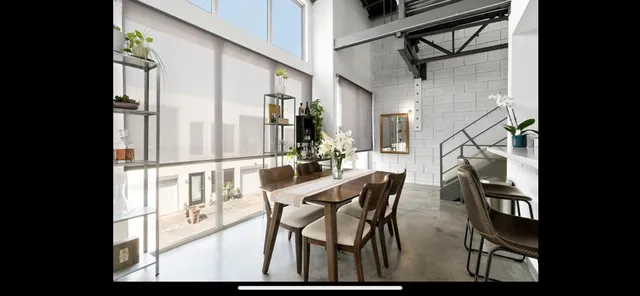 a view of a dining room with furniture and wooden floor