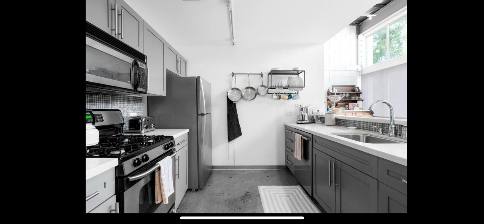 4801 South Congress Avenue, Unit F4 Austin, TX 78745 - Photo 9 of 22 a kitchen with stainless steel appliances granite countertop a stove a sink and a refrigerator
