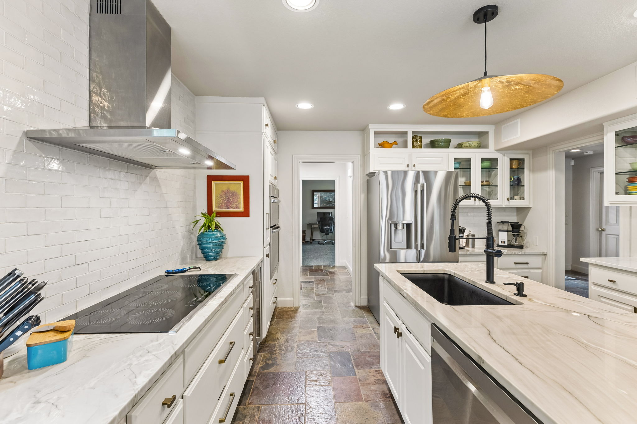1807 Terminal Loop Road McQueeney, TX 78123 - Photo 10 of 40 Polished stone countertops pair elegantly with slate tile flooring in this renovated kitchen space.