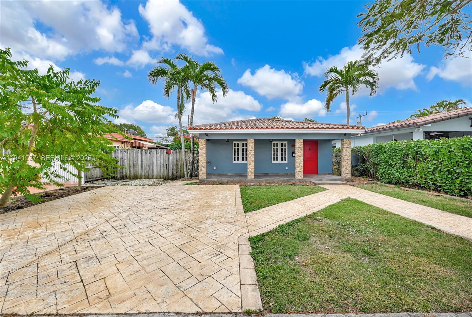 6560 Southwest 39th Street Miami, FL 33155 - Photo 1 of 17 a front view of a house with a garden