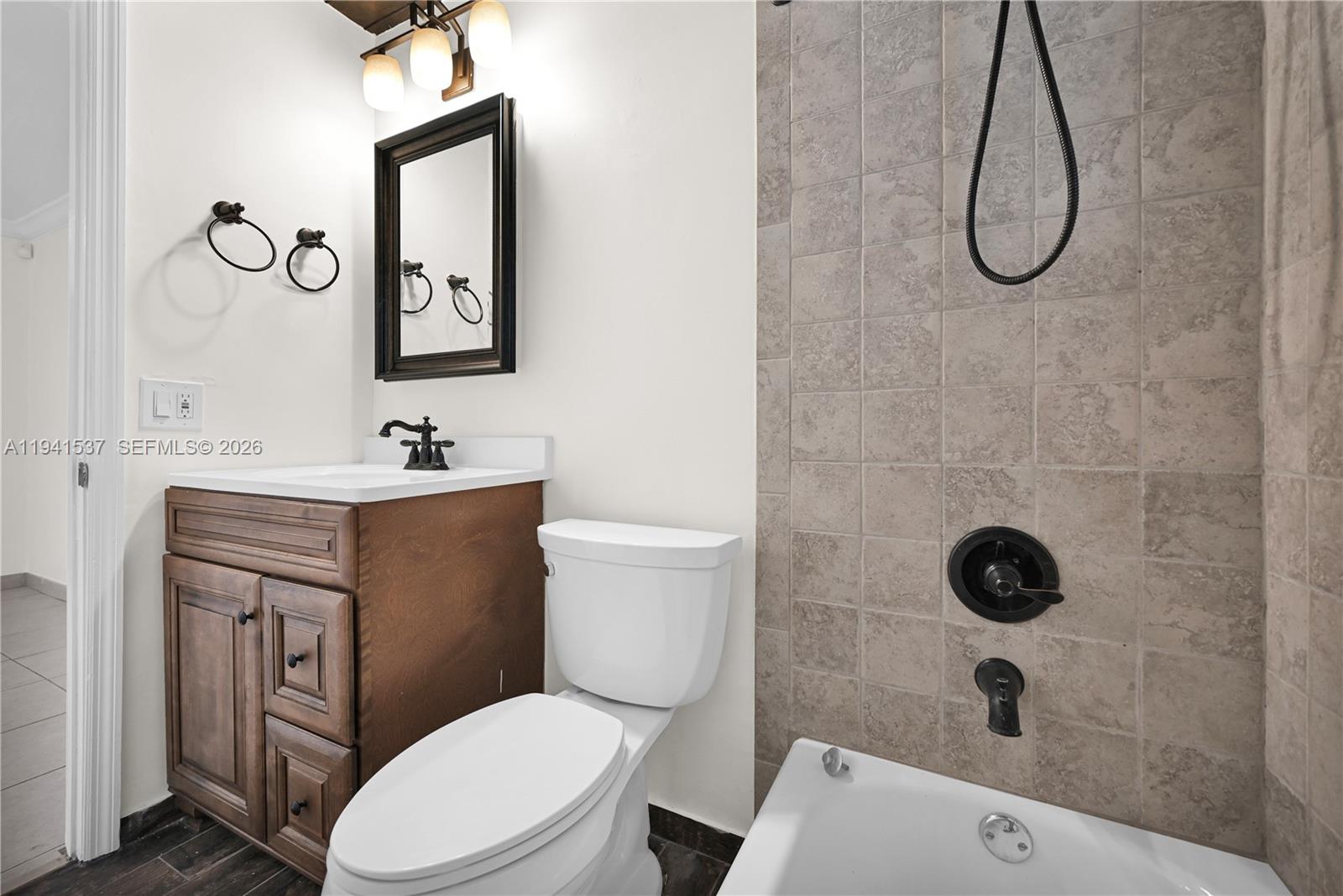 6560 Southwest 39th Street Miami, FL 33155 - Photo 8 of 17 a bathroom with a toilet sink and mirror