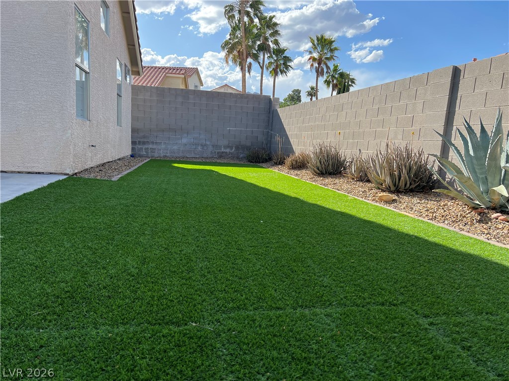 9708 Ridge Creek Place Las Vegas, NV 89134 - Photo 31 of 34 Lush green artificial turf and desert landscaping define this low-maintenance private yard.