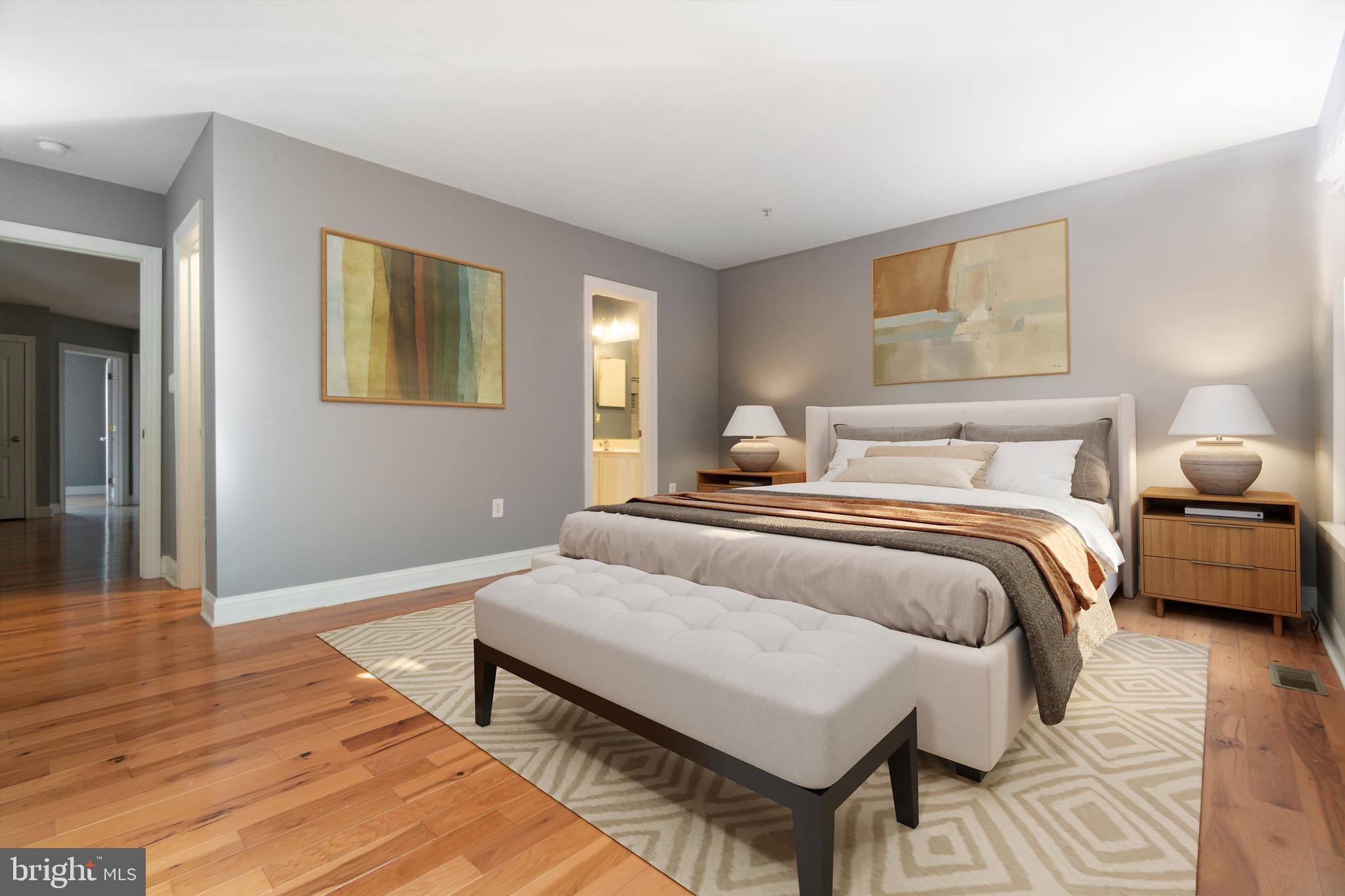 104 Bucksfield Road, Unit 104 Gaithersburg, MD 20878 - Photo 14 of 39 a bedroom with a bed and wooden floor