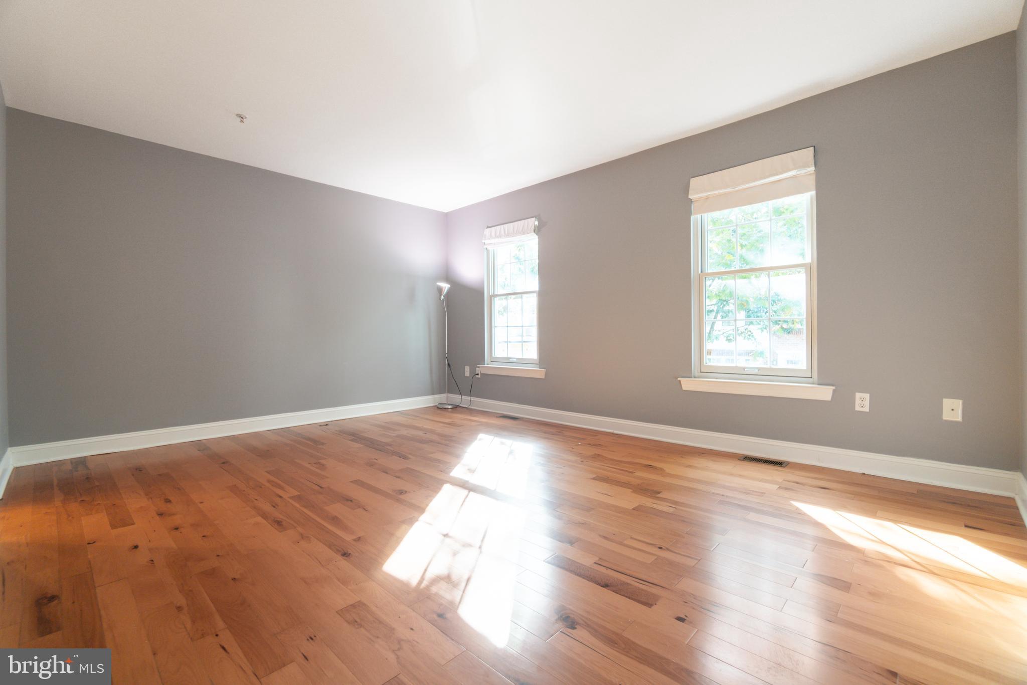 104 Bucksfield Road, Unit 104 Gaithersburg, MD 20878 - Photo 15 of 39 a view of empty room with wooden floor and fan