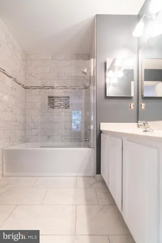 a bathroom with a bathtub and a sink
