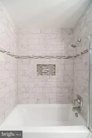 a bathroom with a bathtub and shower