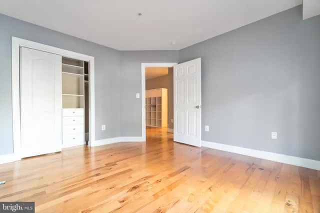 a view of an empty room with wooden floor
