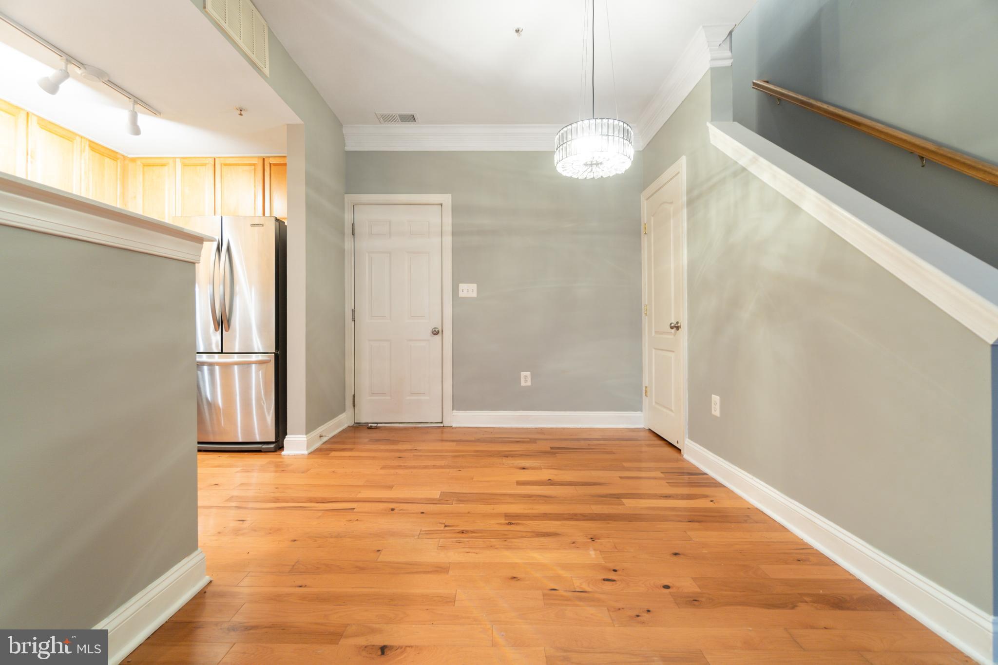 104 Bucksfield Road, Unit 104 Gaithersburg, MD 20878 - Photo 6 of 39 a view of a big room with wooden floor and windows
