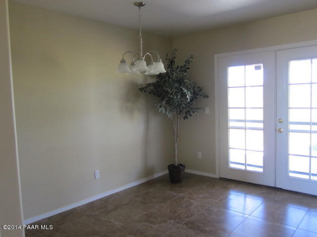 850 West Iris Road Paulden, AZ 86334 - Photo 5 of 17 an empty room with a windows and a chandelier fan