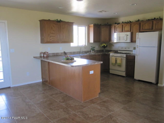 850 West Iris Road Paulden, AZ 86334 - Photo 6 of 17 a kitchen with stainless steel appliances granite countertop a sink stove and refrigerator