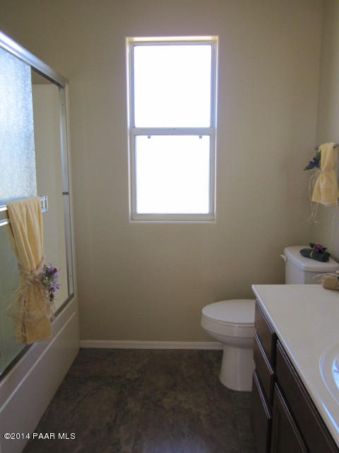 850 West Iris Road Paulden, AZ 86334 - Photo 9 of 17 a bathroom with a toilet a sink and a window