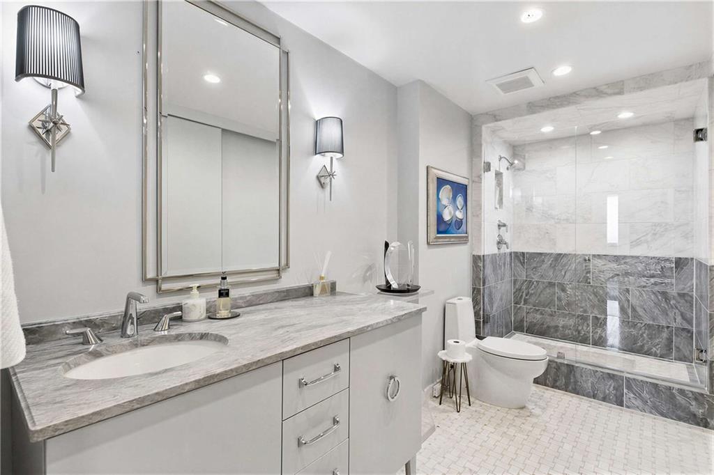 2660 Peachtree Road Northwest, Unit 34F Atlanta, GA 30305 - Photo 30 of 57 a bathroom with a granite countertop sink mirror and toilet