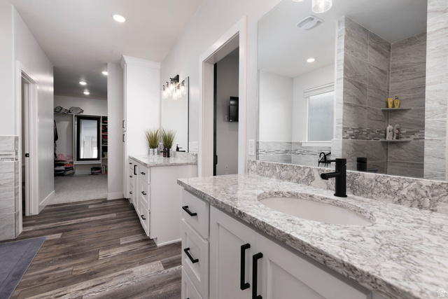186 West 580 North Redmond, UT 84652 - Photo 25 of 74 Full bathroom with two vanities, dark wood finished floors, and recessed lighting