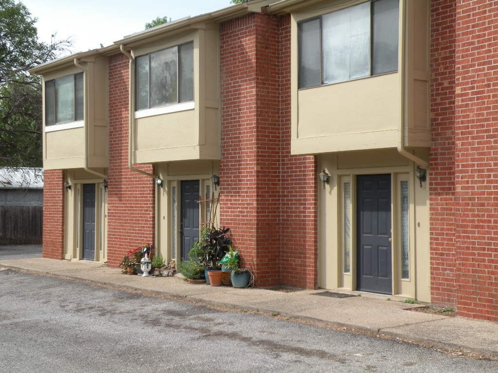1221 Hopkins Street, Unit 8 San Marcos, TX 78666 - Photo 10 of 14 a view of a brick house with potted plants