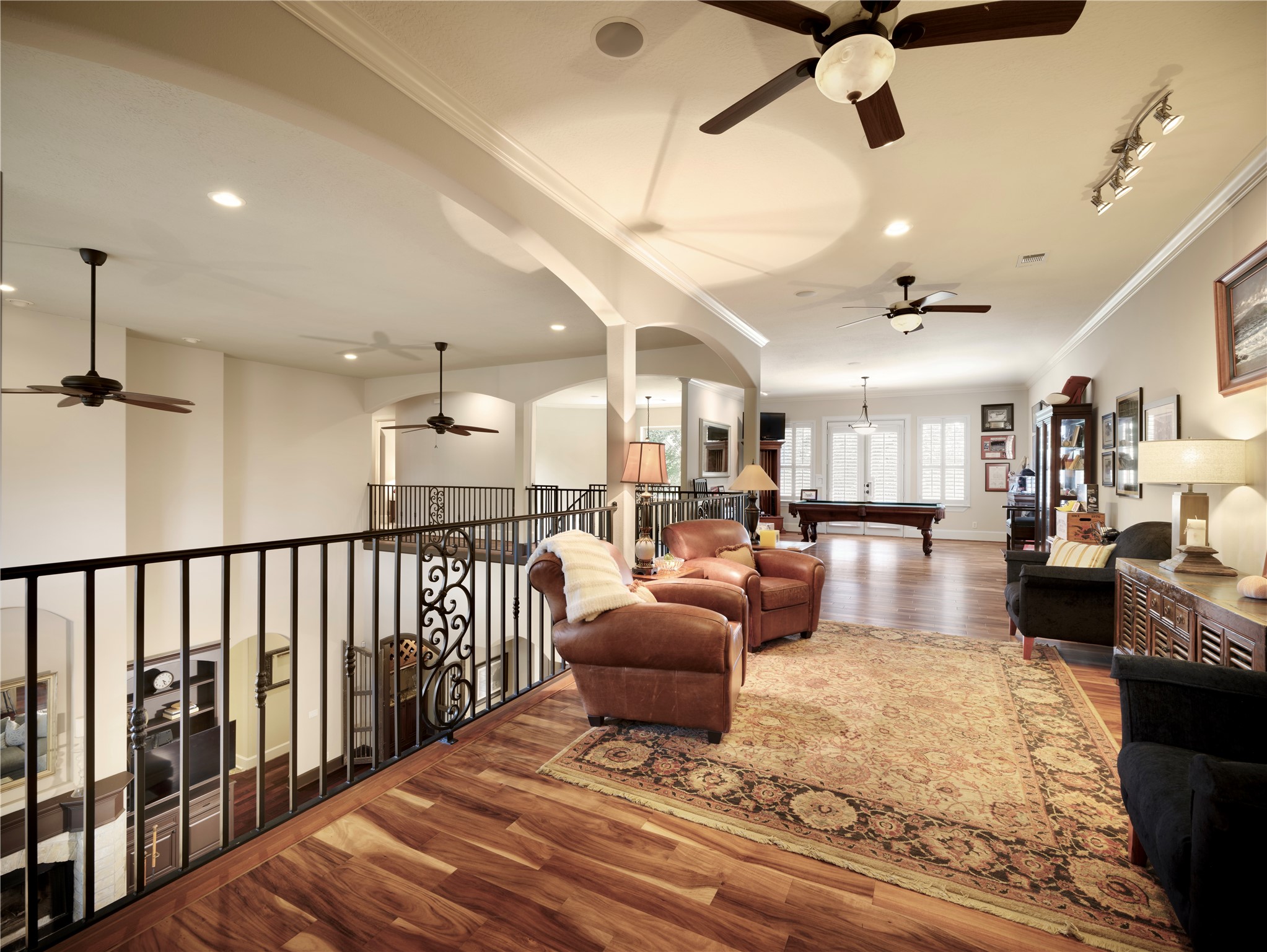 6702 Star Ledge Court Spring, TX 77389 - Photo 16 of 39 BILLIARDS & GAME ROOM – Overlooking the dramatic two-story great room below, this expansive upper-level retreat is designed for recreation, relaxation, and entertaining. With ample space for billiards, game tables, media viewing, and multiple conversation areas, it easily accommodates gatherings both large and small. Rich hardwood floors, soaring ceilings, and an open architectural design create an inviting atmosphere that extends the home’s generous living spaces while offering endless possibilities.