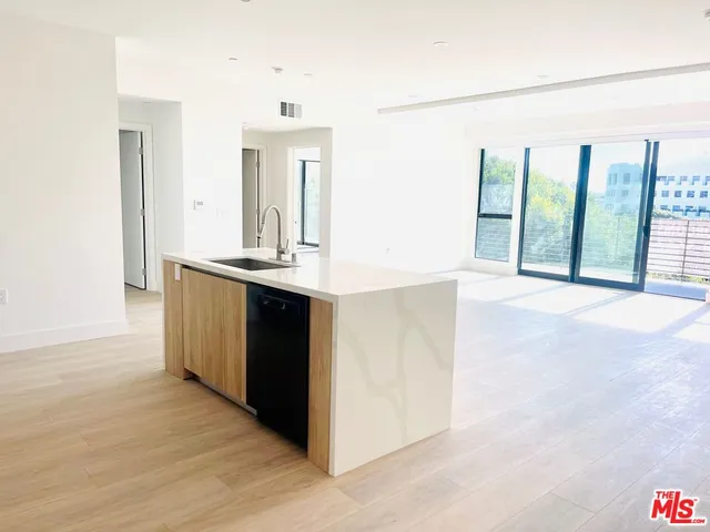 a view of a kitchen with a sink and a large window