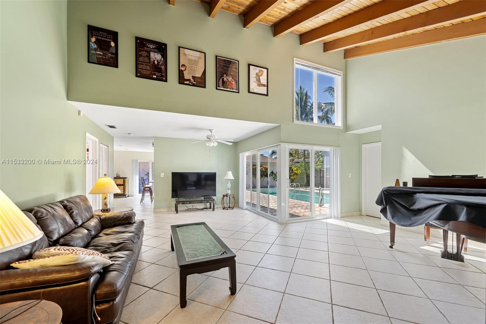 113 Kensington Road Hollywood, FL 33021 - Photo 9 of 32 Living room. Beautiful, vaulted ceiling, skylight, impact windows. Bright & spacious!