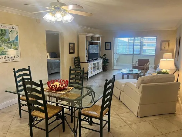 a living room with furniture a chandelier and a flat screen tv