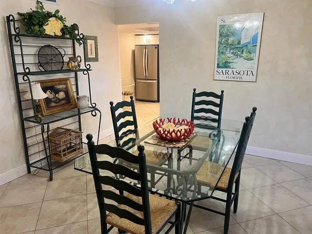 a view of a dining room with furniture and a kitchen