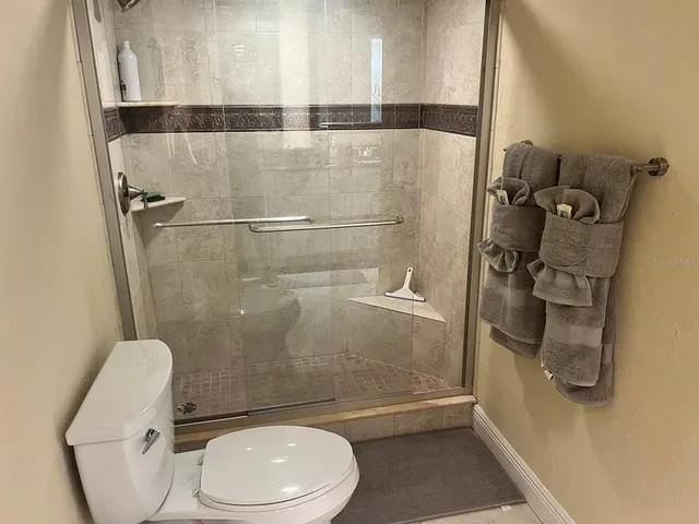 a bathroom with a toilet and a shower