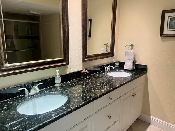 a bathroom with sinks granite and a sink