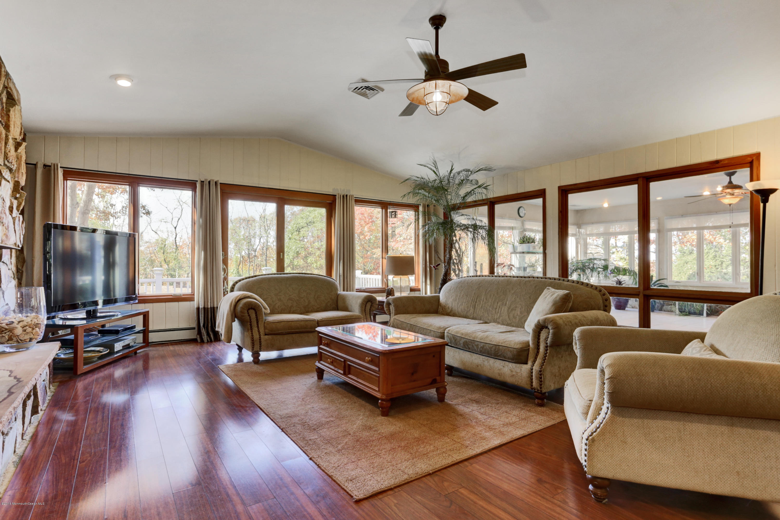 255 Portland Road Middletown, NJ 07737 - Photo 14 of 41 a living room with furniture ceiling fan and a large window