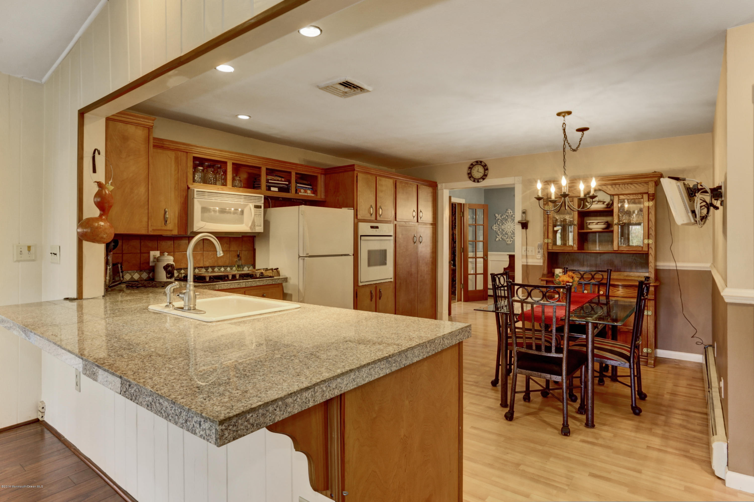 255 Portland Road Middletown, NJ 07737 - Photo 16 of 41 a kitchen with stainless steel appliances kitchen island granite countertop a table chairs and a refrigerator