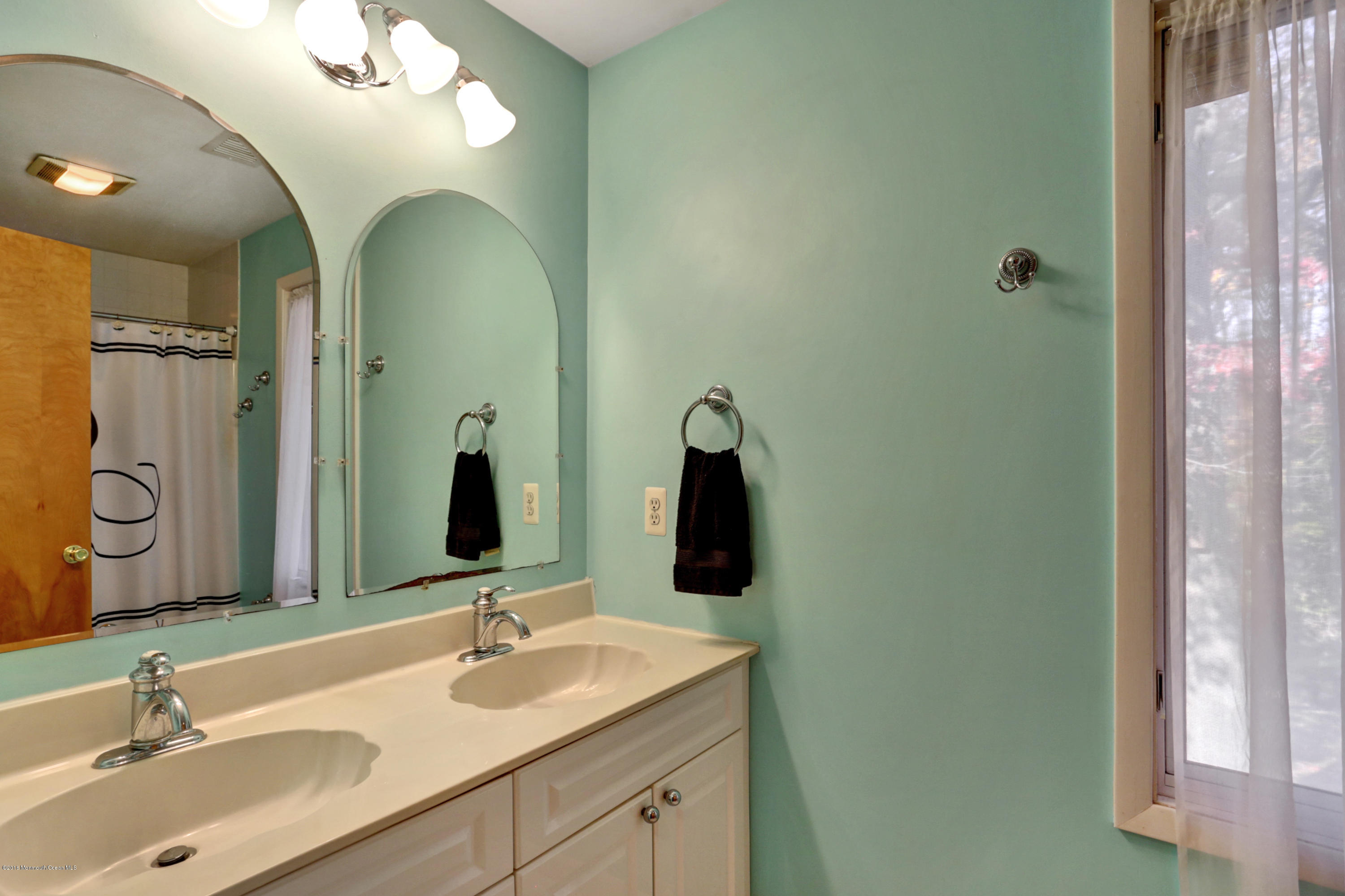 255 Portland Road Middletown, NJ 07737 - Photo 24 of 41 a bathroom with a double vanity sink and a mirror