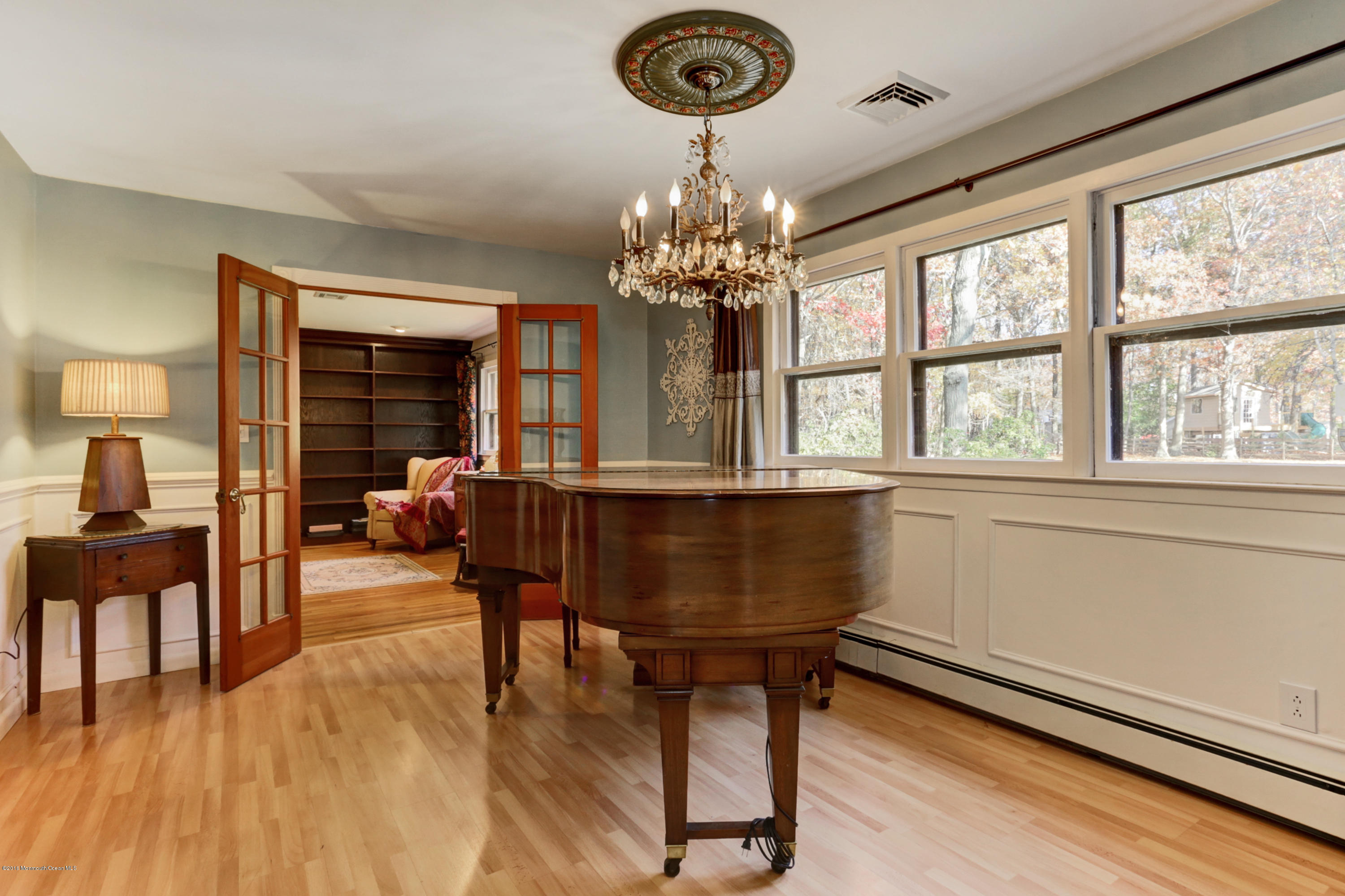 255 Portland Road Middletown, NJ 07737 - Photo 7 of 41 a living room with furniture and a chandelier