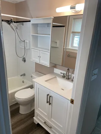 a bathroom with a sink toilet and shower