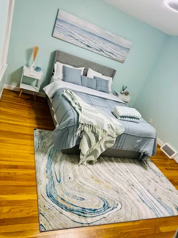 a bedroom with a bed and a mirror