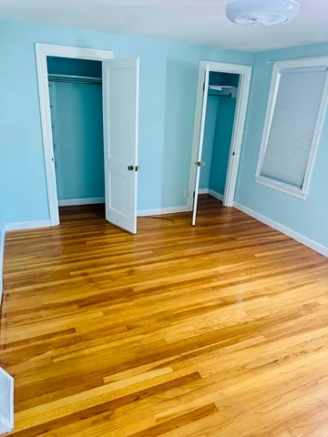 a view of a room with wooden floor