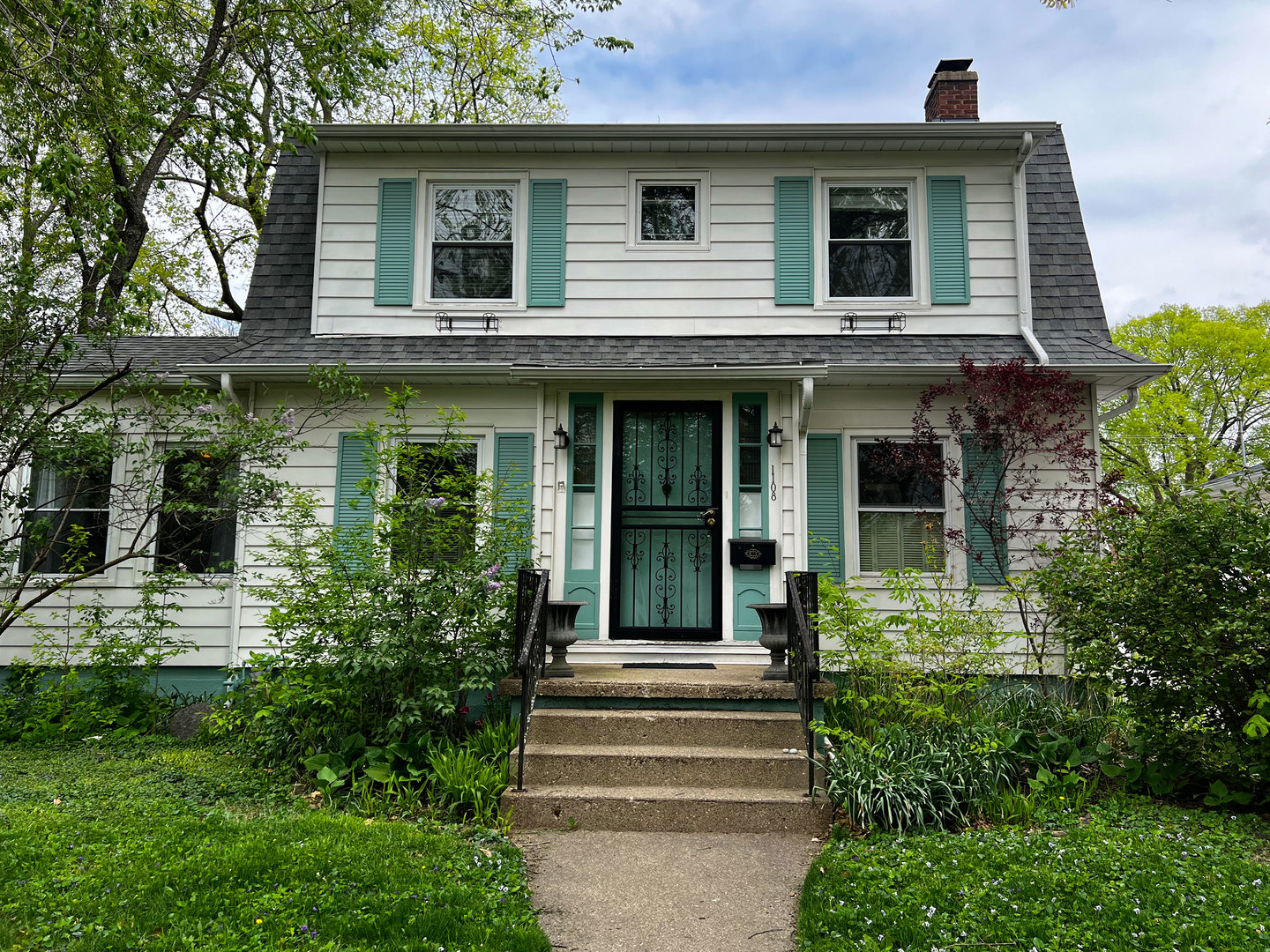 1108 West Daniel Street Champaign, IL 61821 - Photo 1 of 55 a view of a house with potted plants and a table and chairs
