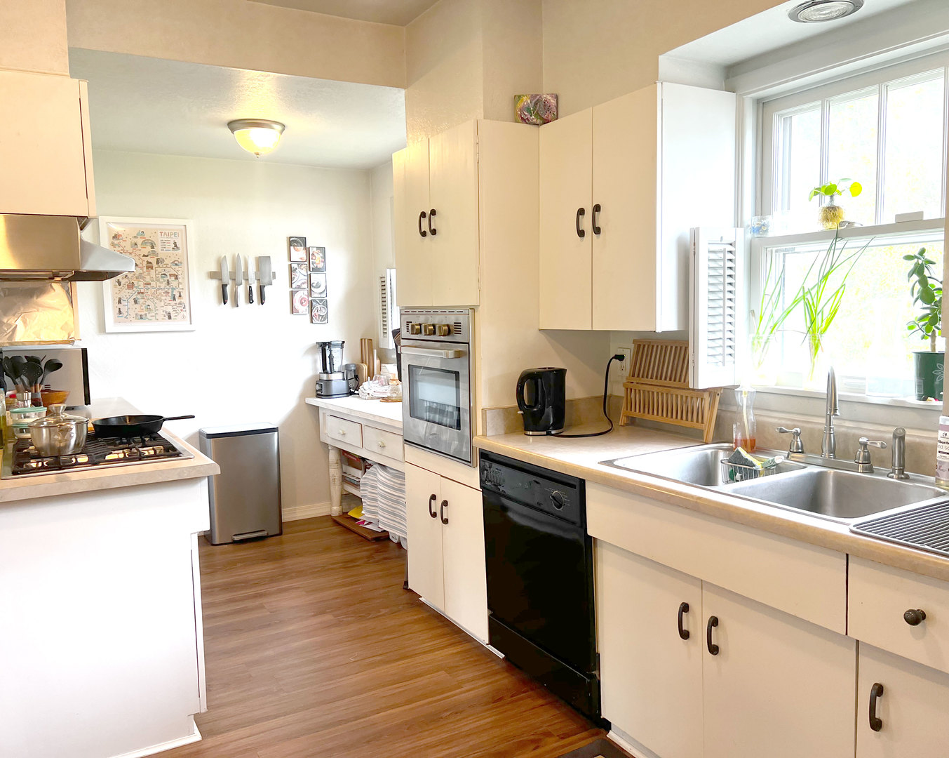 1108 West Daniel Street Champaign, IL 61821 - Photo 14 of 55 a kitchen with kitchen island granite countertop a sink appliances cabinets and a large window