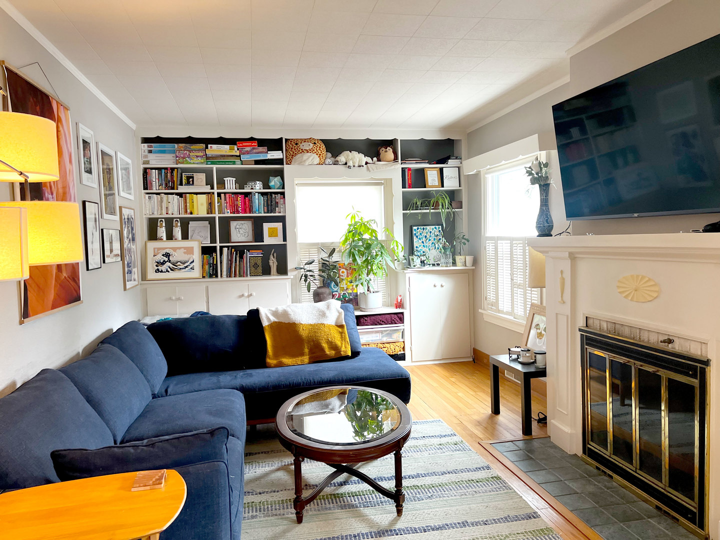 1108 West Daniel Street Champaign, IL 61821 - Photo 6 of 55 a living room with furniture a flat screen tv and a fireplace