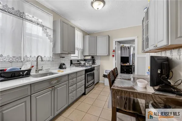 a kitchen with stainless steel appliances granite countertop a stove top oven a sink dishwasher and cabinets with wooden floor